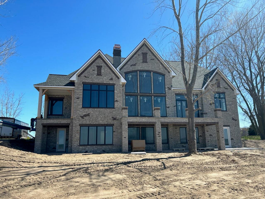 New construction luxury home with uncapped chimneys — custom chimney caps for new builds fabricated to order by Archaic Metal