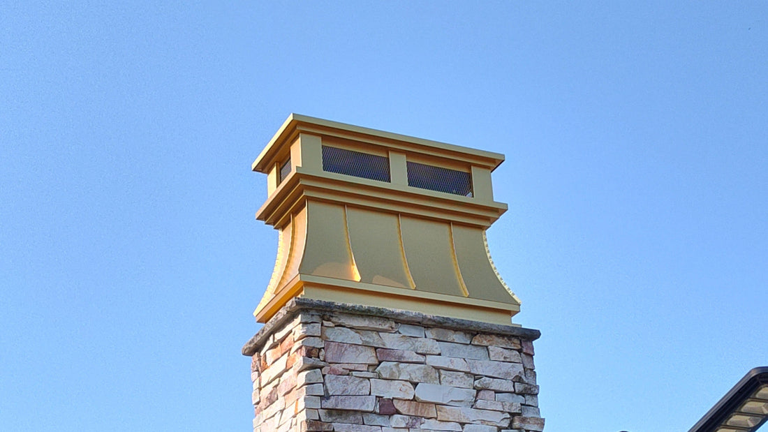 Custom copper chimney shroud installed on stone chimney — decorative enclosure helps correct wind-related smoke backdraft