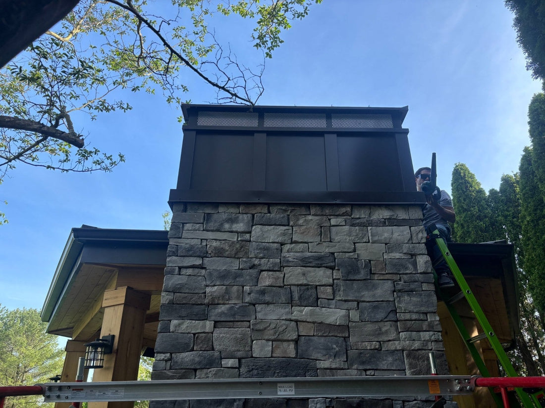 Custom board and batten extended height chimney cap installed on large stone masonry chimney