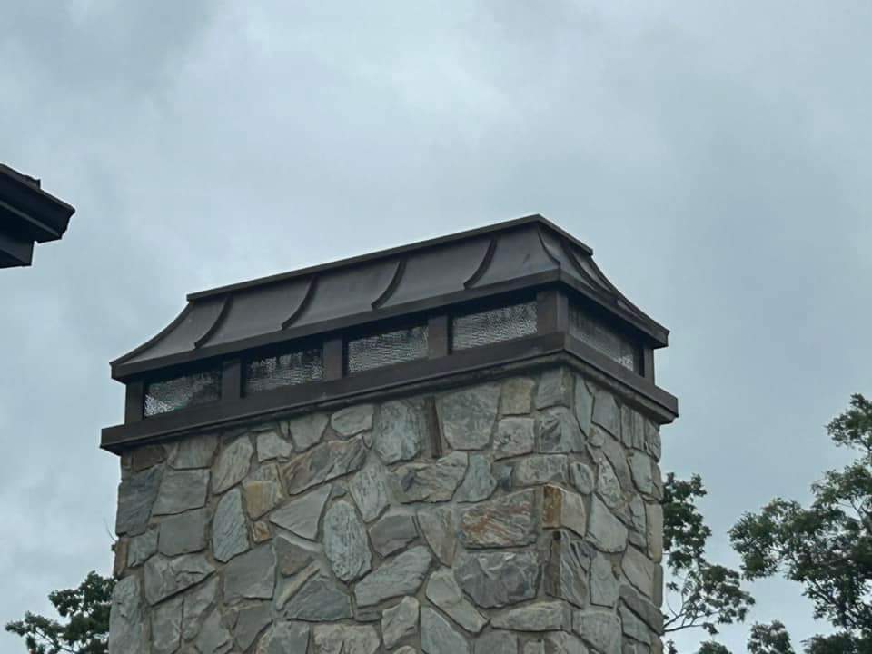 Copper chimney cap on a stone chimney with aged patina archaicmetal nj