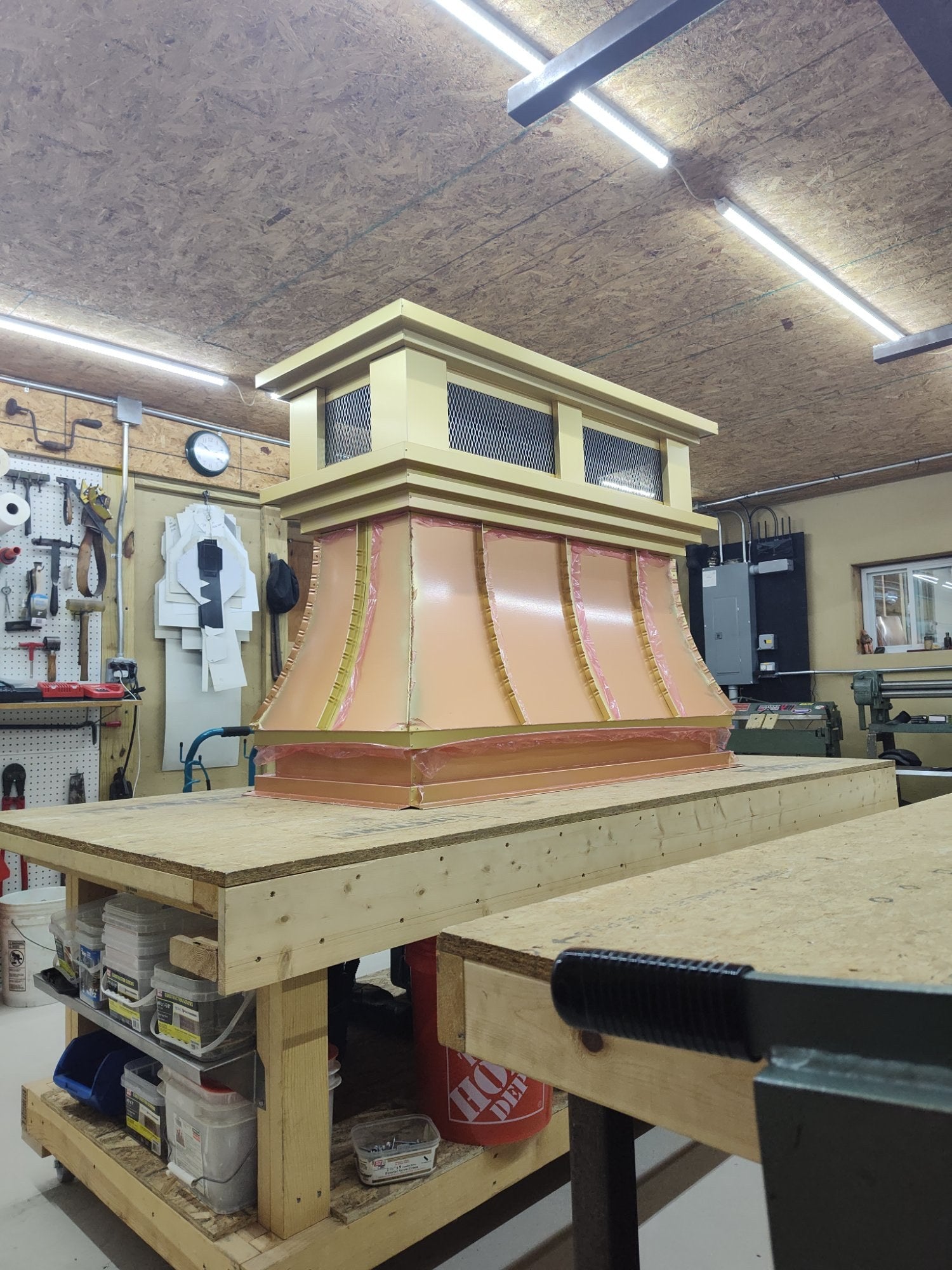 Detail view of gold anodized aluminum chimney cap crown section — hip roof lid with stainless steel expanded spark screen, handmade in Berlin NJ by Archaic Metal