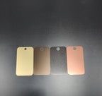 Four Lorin anodized aluminum finish samples — matte gold, bronze, BlackMatt, and medium antique copper — available finish options for curved panel chimney caps by Archaic Metal