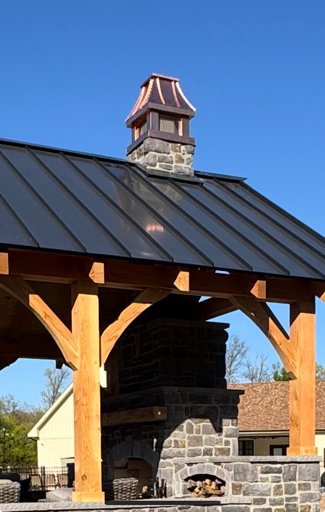 Side mount copper chimney cap installed on stone masonry chimney — 16 oz copper, hand-fabricated by Archaic Metal
