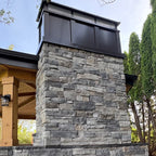 board and batten dark bronze chimney cap on a stone outdoor fireplace chimney berlin nj