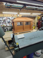 Board and batten extended height chimney cap in Kynar copper finish, front shop view