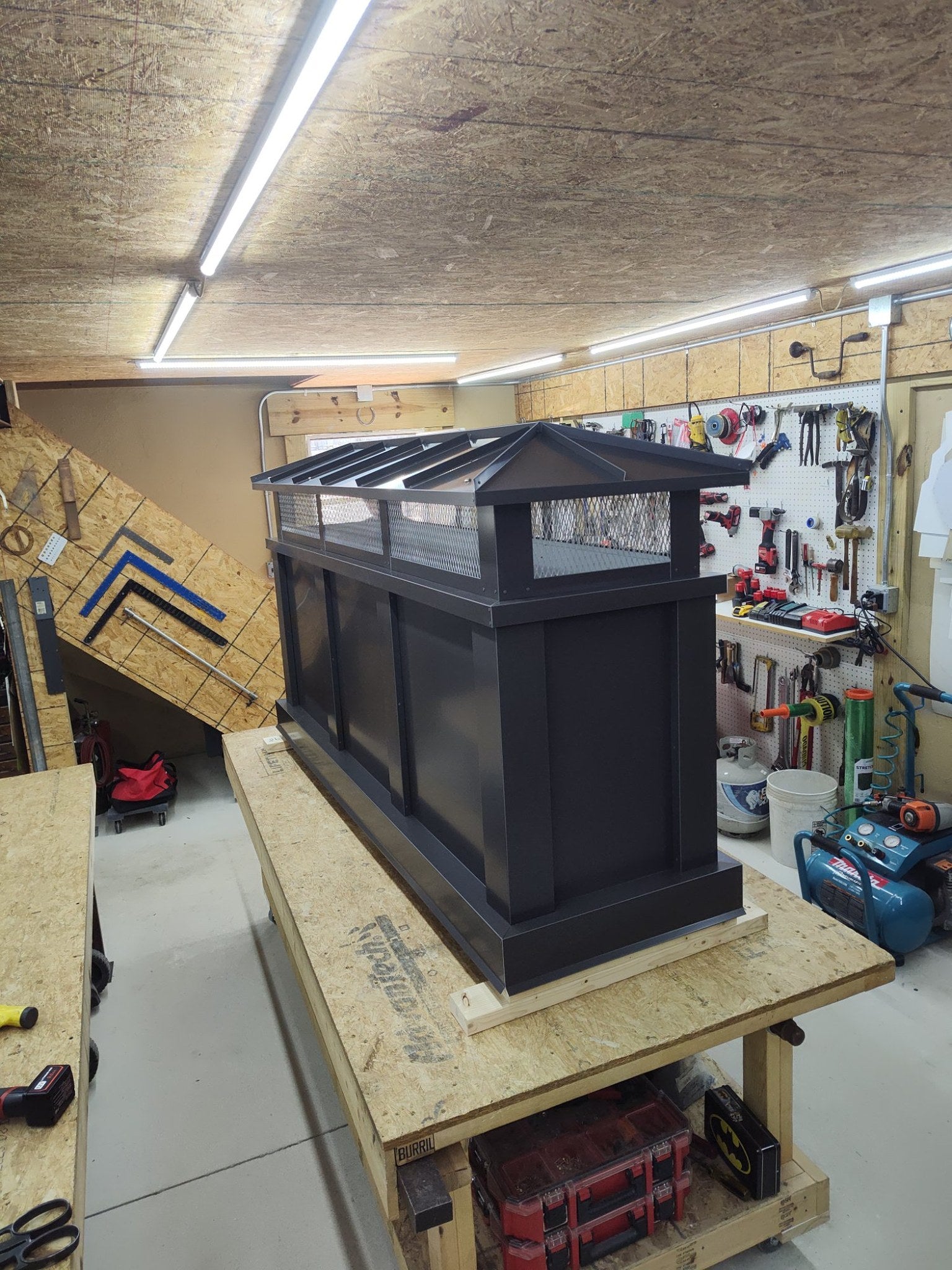 Custom board and batten extended height chimney cap, Kynar black, three-quarter angle