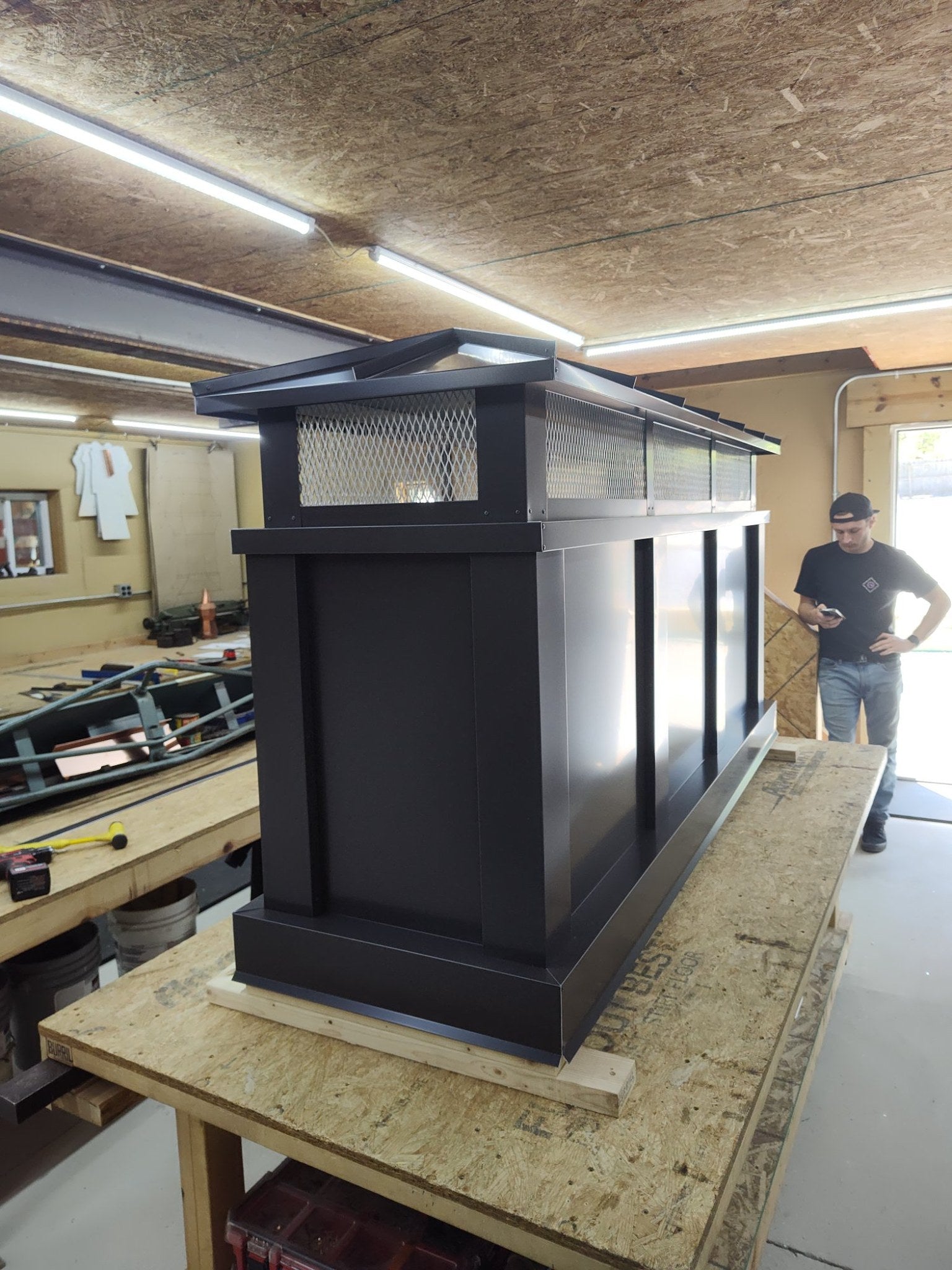 Large Kynar black board and batten top vent cap, front view showing hip roof and vent screen