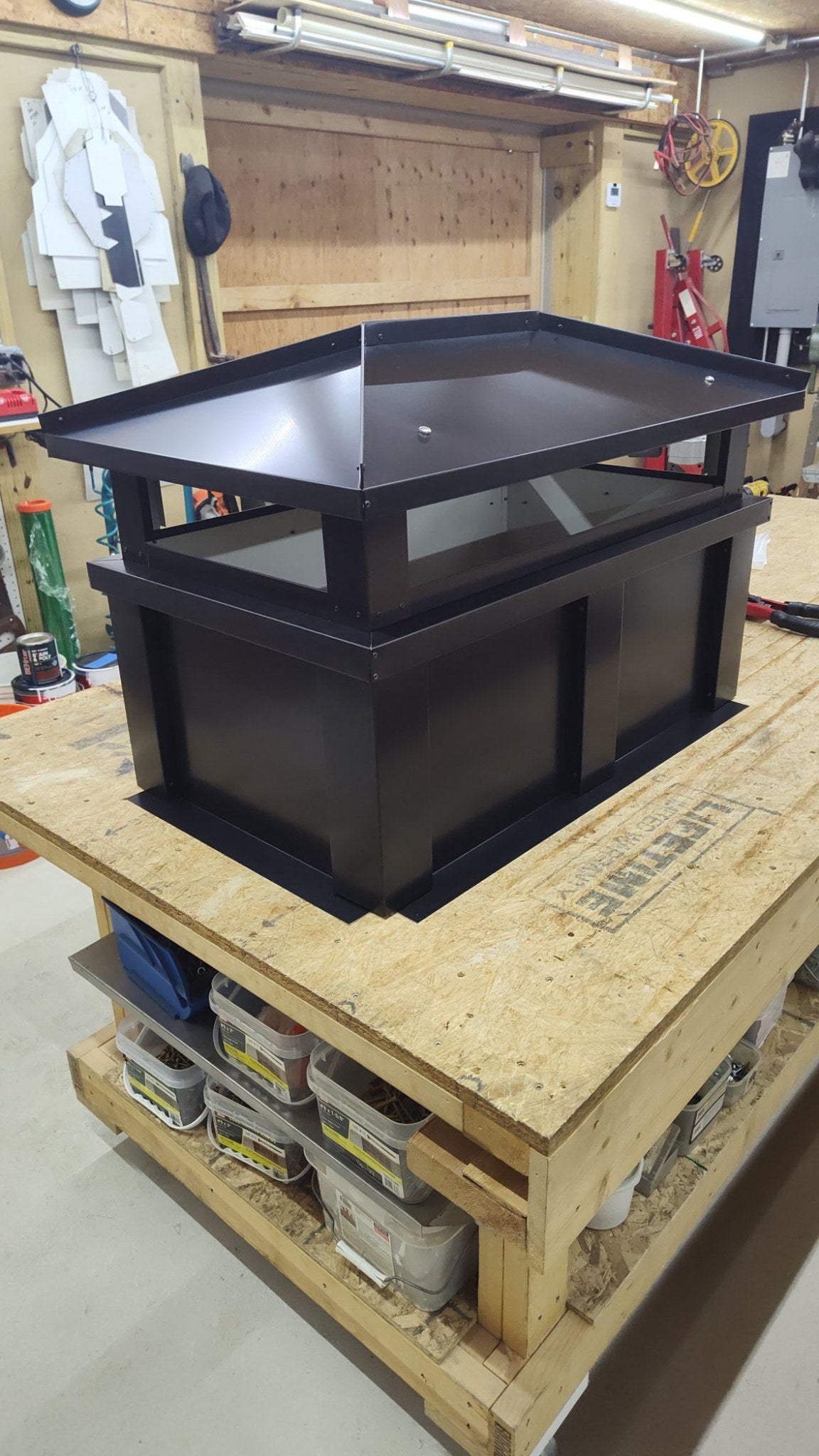 Kynar black board and batten chimney cap, front view showing solid base and vented top section
