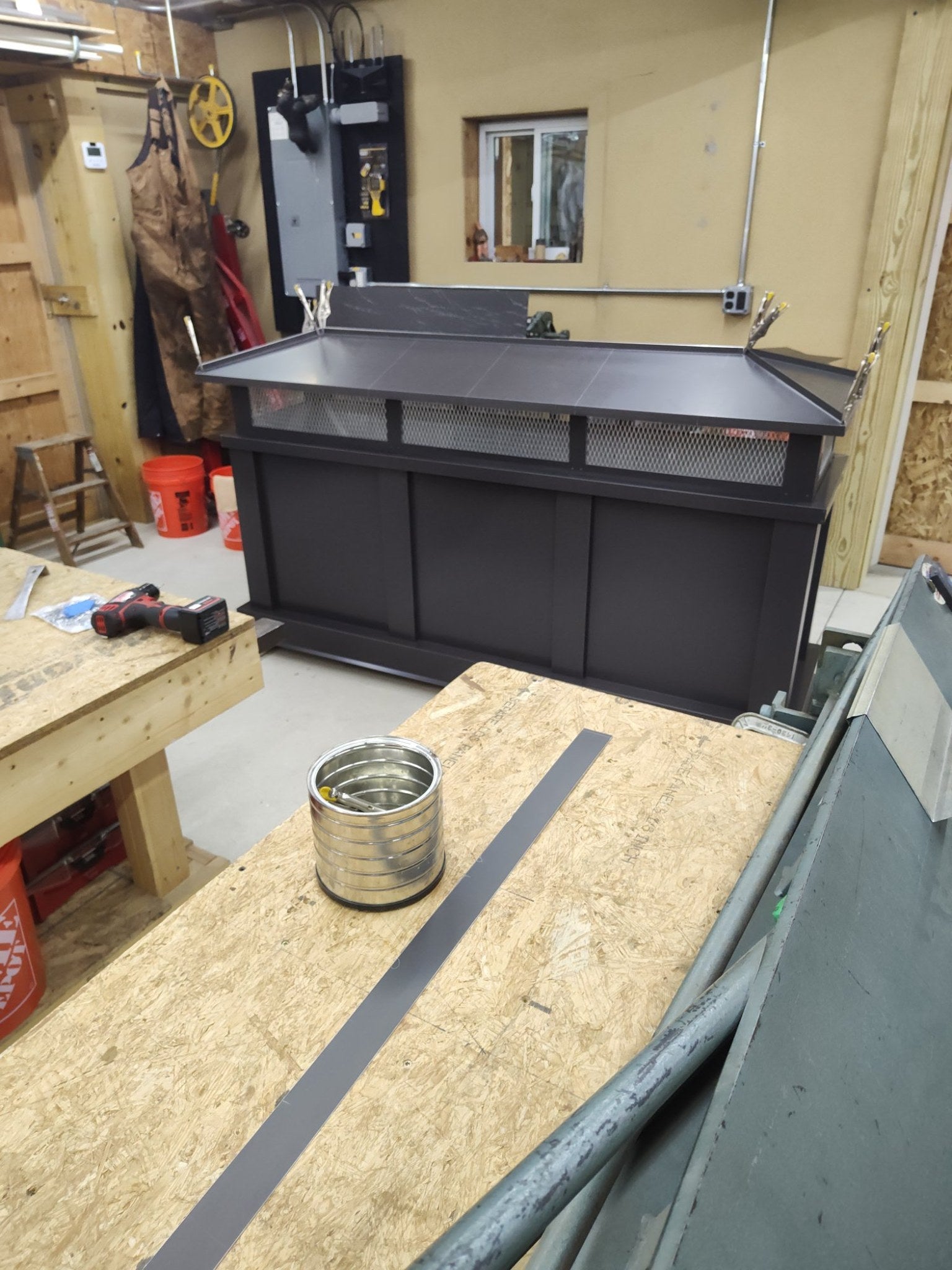 Kynar black board and batten top vent cap, single-flue size, front view on workbench