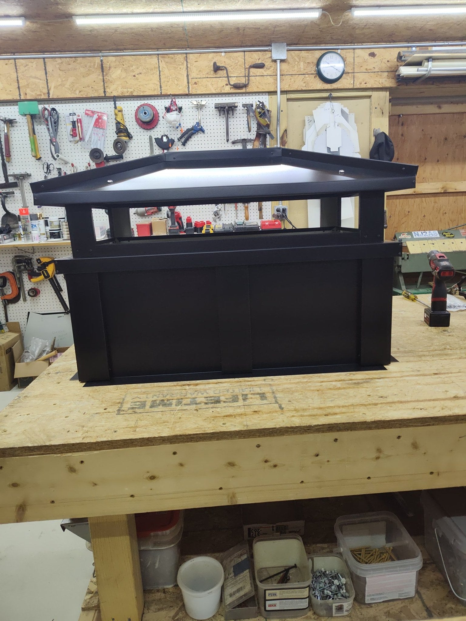 Large Kynar black board and batten extended height cap, front view showing multi-flue proportions