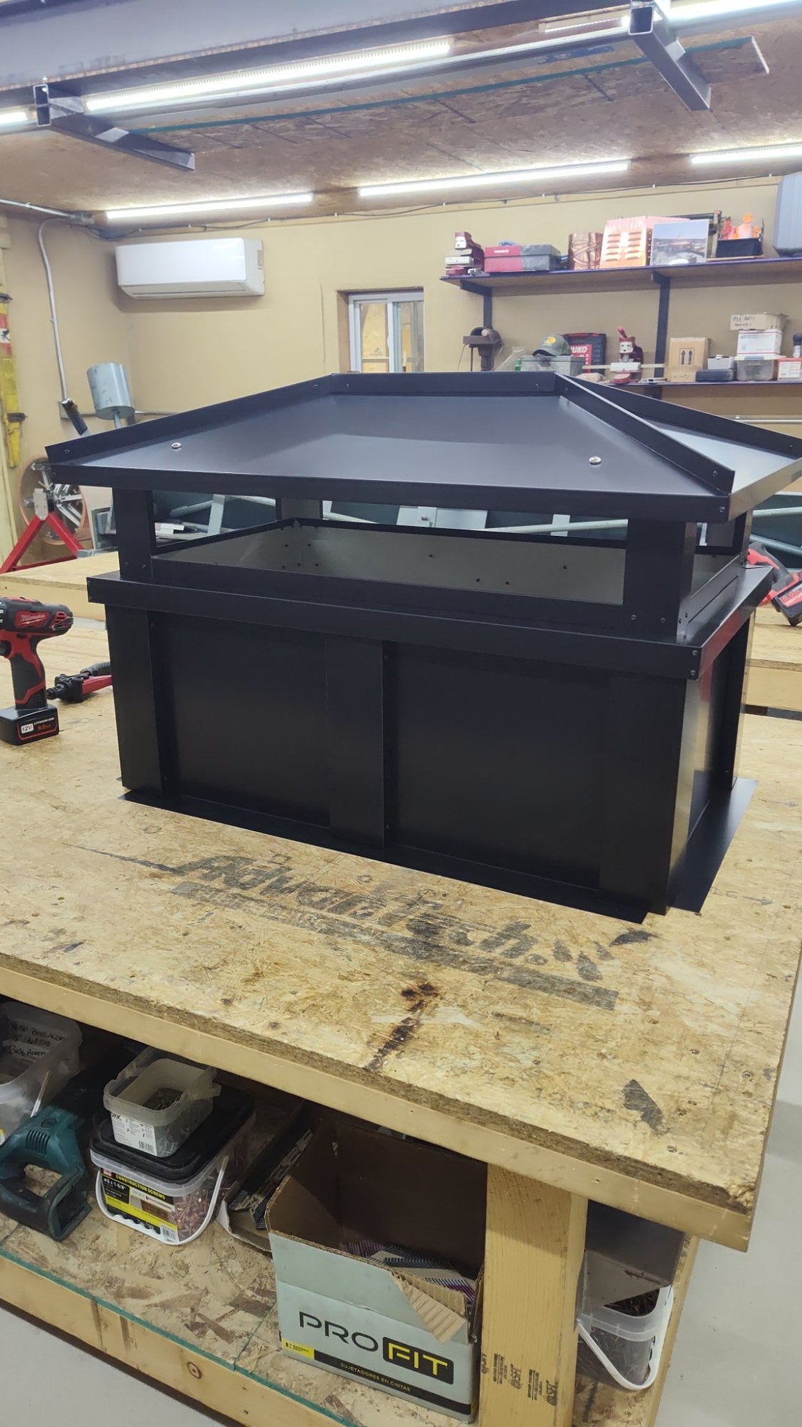 Custom board and batten top vent chimney cap, Kynar black, single-flue, front bench view