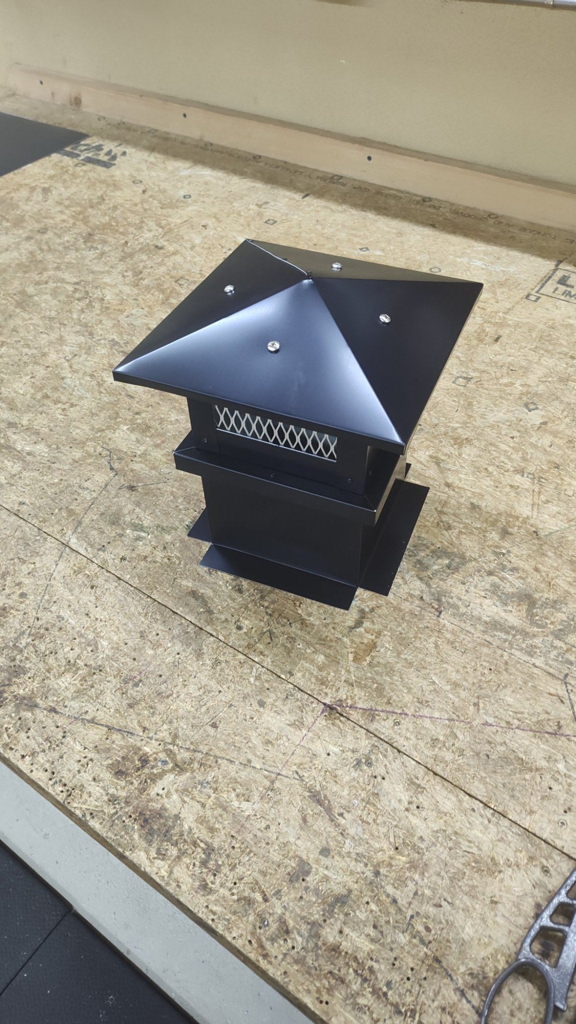 Kynar black board and batten top vent cap, small single-flue, clean front view