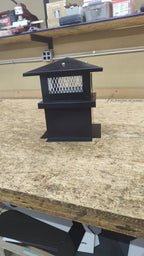 Small Kynar black board and batten chimney cap, front view on workbench