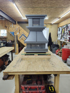 Crown top vent chimney cap in Kynar gray, front view on workbench — Archaic Metal