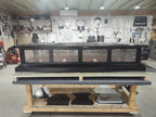 Custom multi-flue cap side profile — black Kynar aluminum with full perimeter stainless steel mesh