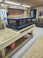 Multi-flue chimney cap installed on rooftop — wide profile flat top design in black Kynar