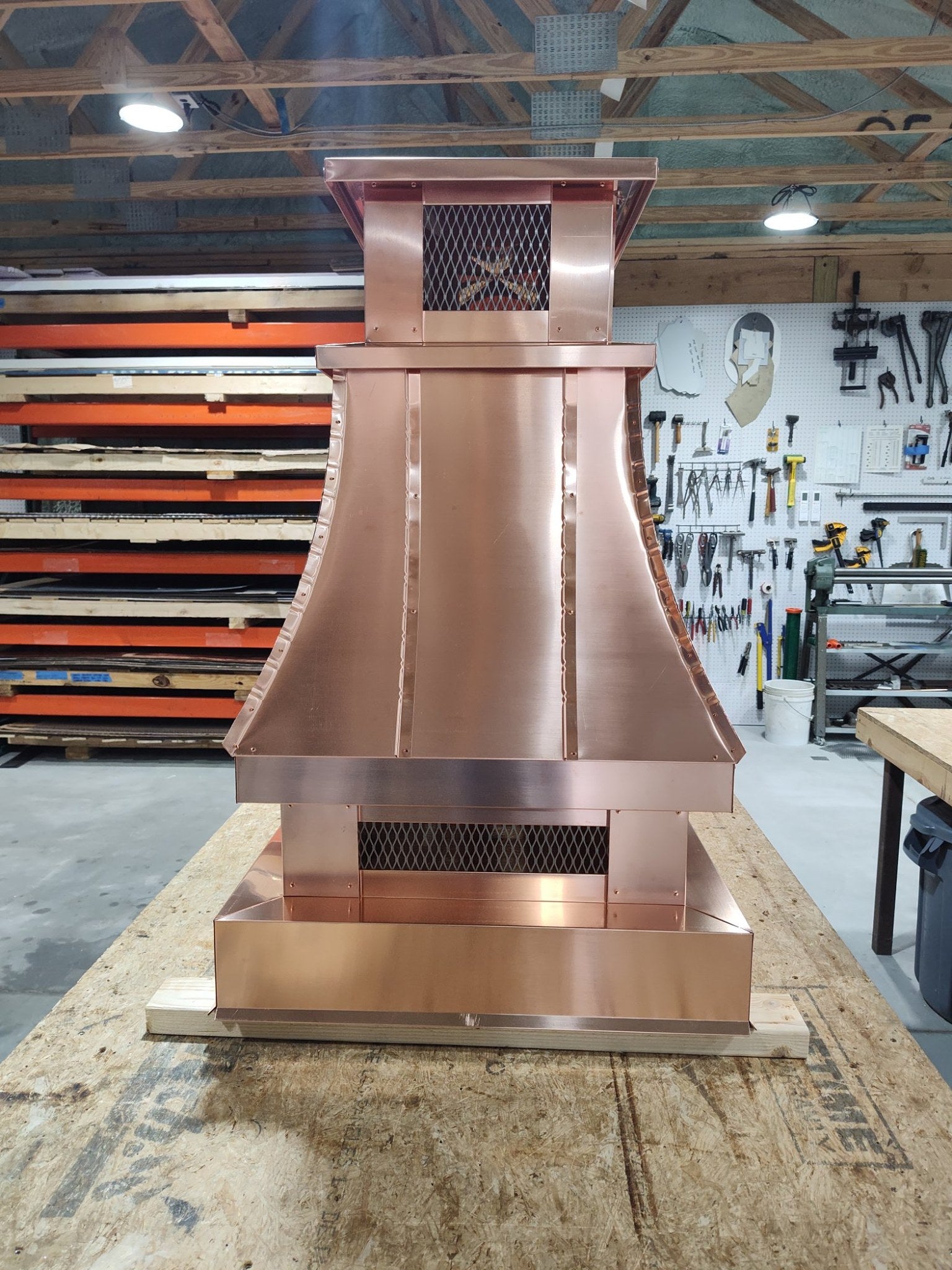 Copper top vent curved panel cap, front-facing shop view showing expanded metal mesh screen