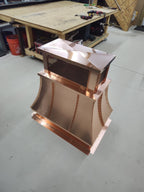 Copper top vent curved panel cap, elevated angle showing flat-top crown and mesh vent screen