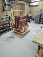 Copper top vent curved panel cap, floor-level three-quarter angle showing full form