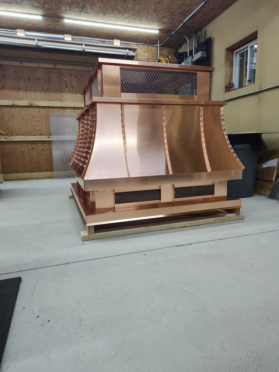 Large multi-flue copper top vent curved panel cap, three-quarter angle view