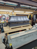 Arched top chimney cap in charcoal grey Kynar aluminum — custom fabricated by Archaic Metal in Berlin NJ