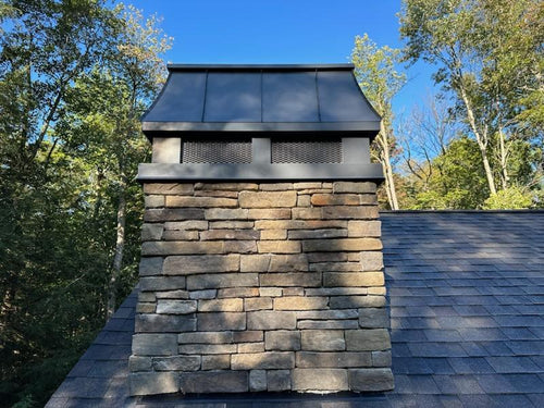 Charcoal grey Kynar aluminum chimney cap installed on stone chimney — custom fabricated by Archaic Metal, Berlin NJ