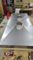 Hemmed edge detail on custom fabricated stainless steel chimney chase cover