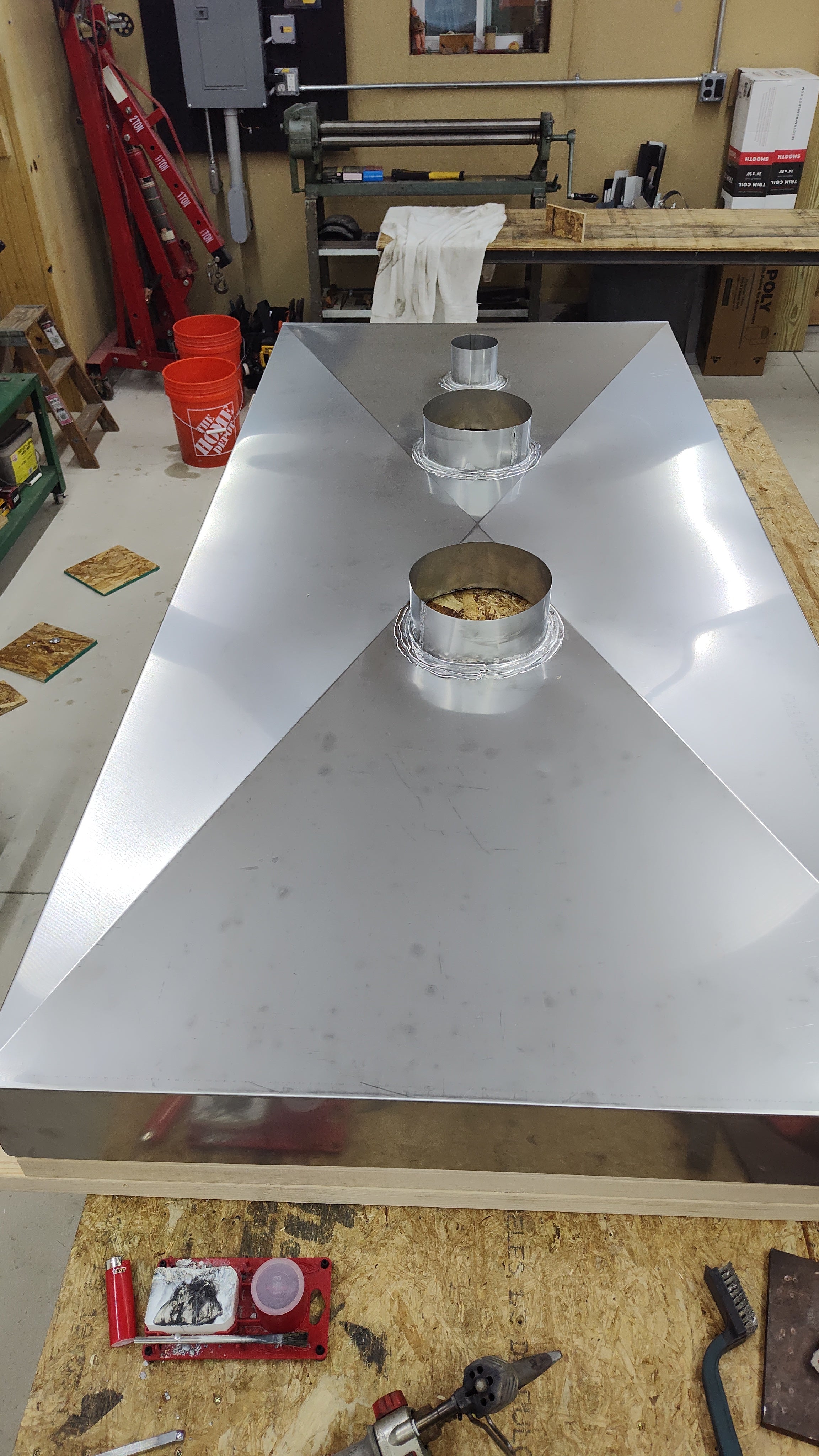 Hemmed edge detail on custom fabricated stainless steel chimney chase cover