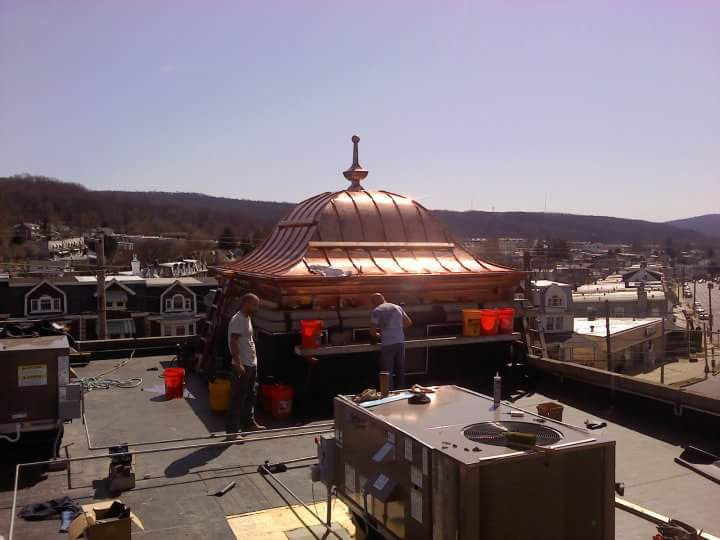 copper bell roof by archaic metal with custom-made built-in copper gutter and roof finial 