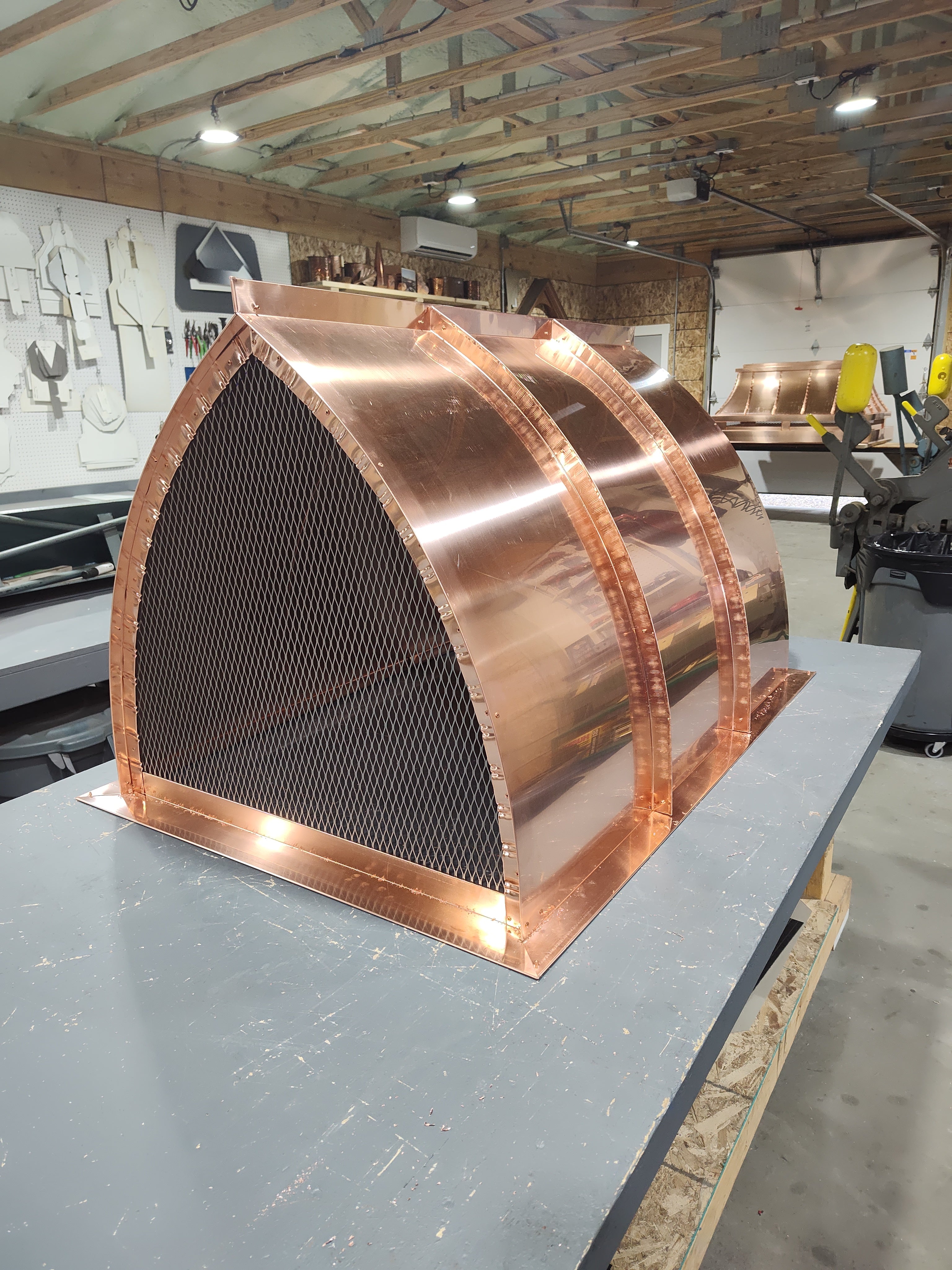 Hand-fabricated copper cathedral chimney cap in progress, custom top mount