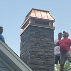 Custom copper chimney cap freshly installed on stone masonry chimney — contractors on rooftop, Archaic Metal fabricated