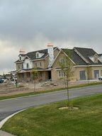New construction suburban home with multiple copper chimney caps installed during build — custom fabricated to order by Archaic Metal