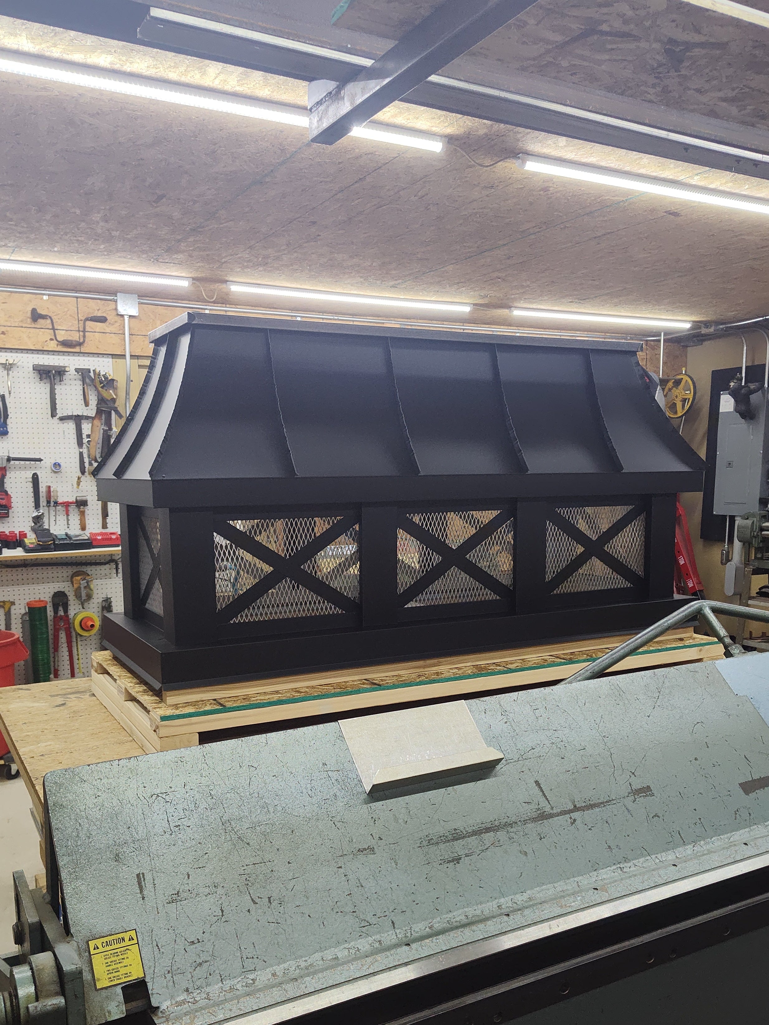 Curved panel Kynar aluminum chimney cap in black with cross buck design

