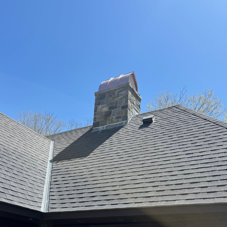 Hand-fabricated copper arched cathedral cap on stone chimney, residential installation Connecticut
