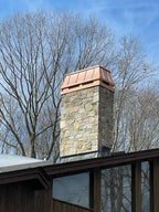 Custom straight panel copper chimney cap installed on stone chimney blue sky — hand-fabricated by Archaic Metal Berlin NJ