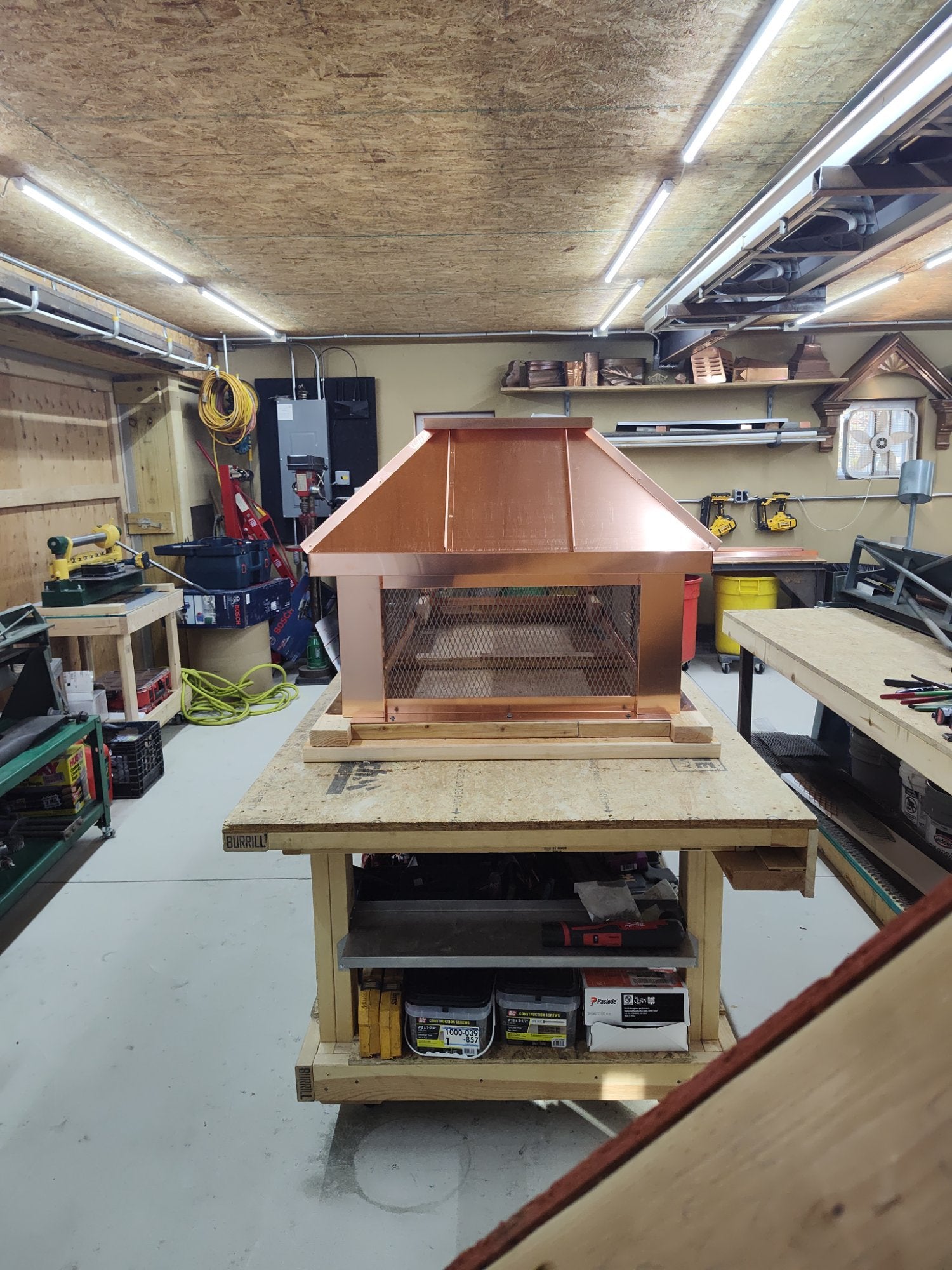 Square custom straight panel copper chimney cap front view on workbench — hand-fabricated by Archaic Metal Berlin NJ