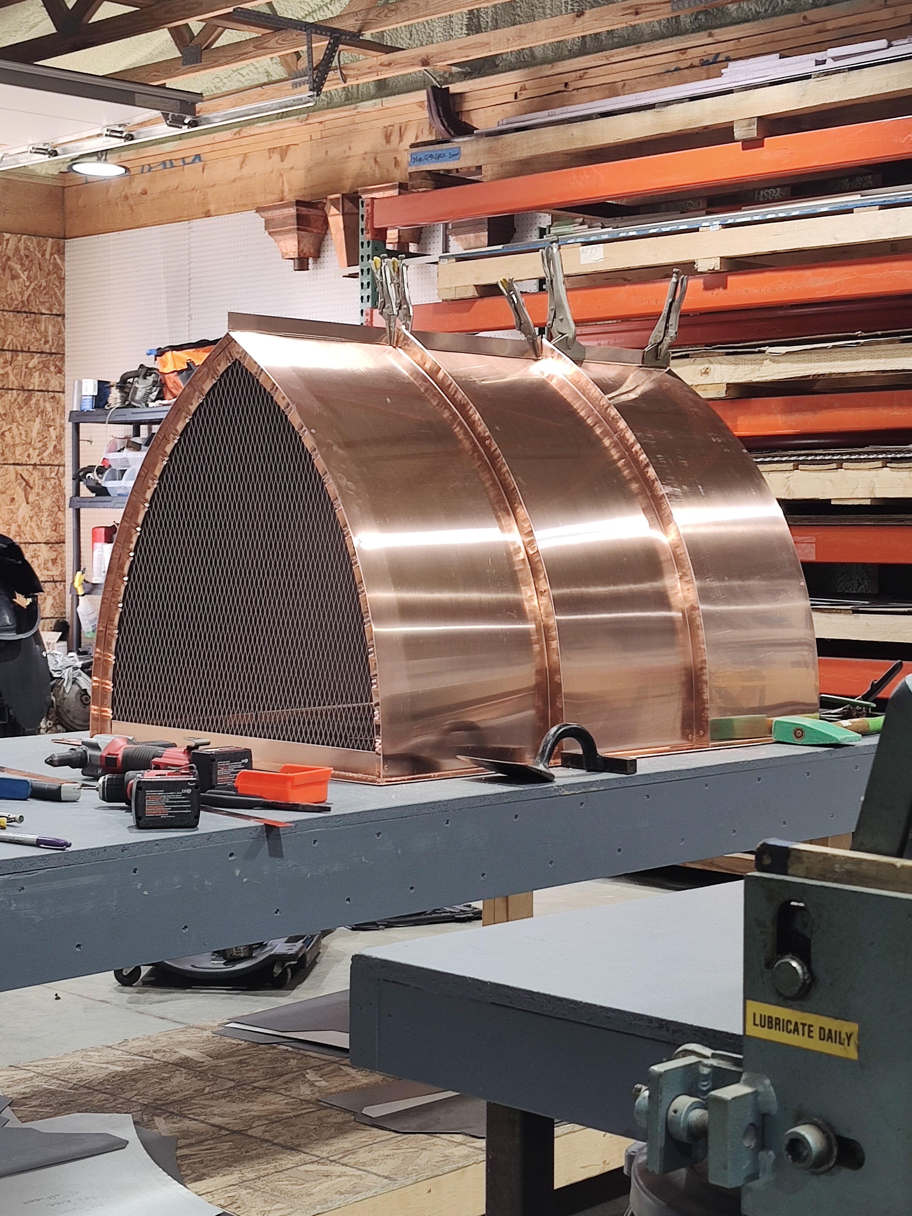 Copper arched cathedral chimney cap end view showing stainless spark screen