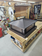 Hip and ridge chimney cap with stainless spark mesh — angle view showing construction

