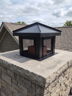 Custom hip and ridge chimney flue cover in Kynar black aluminum installed on stone masonry chimney — top mount, hand-fabricated in Berlin NJ