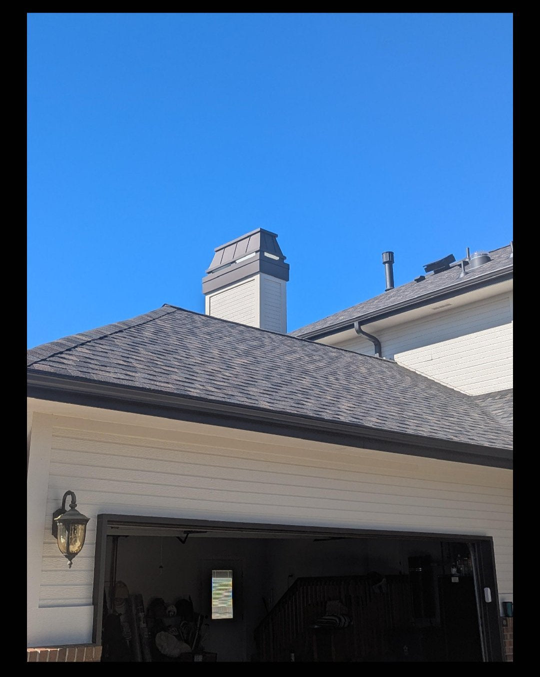 Custom black Kynar aluminum straight panel chimney cap installed on residential home full view — hand-fabricated by Archaic Metal Berlin NJ