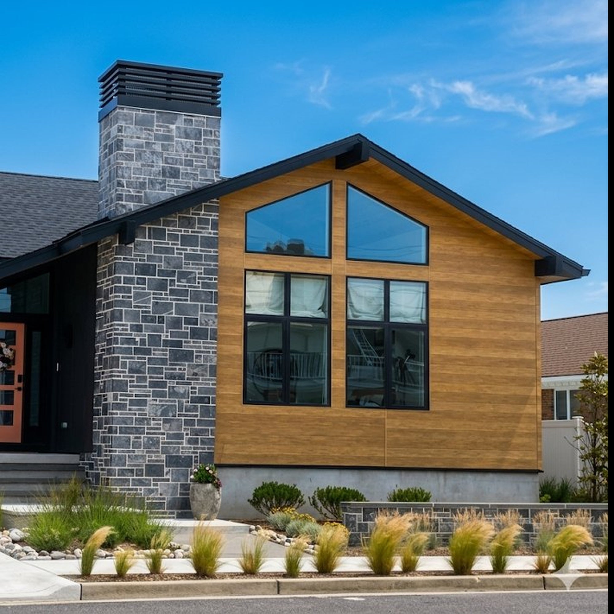 Custom chimney shroud on modern home with stone chimney — louvered chimney cap by Archaic Metal