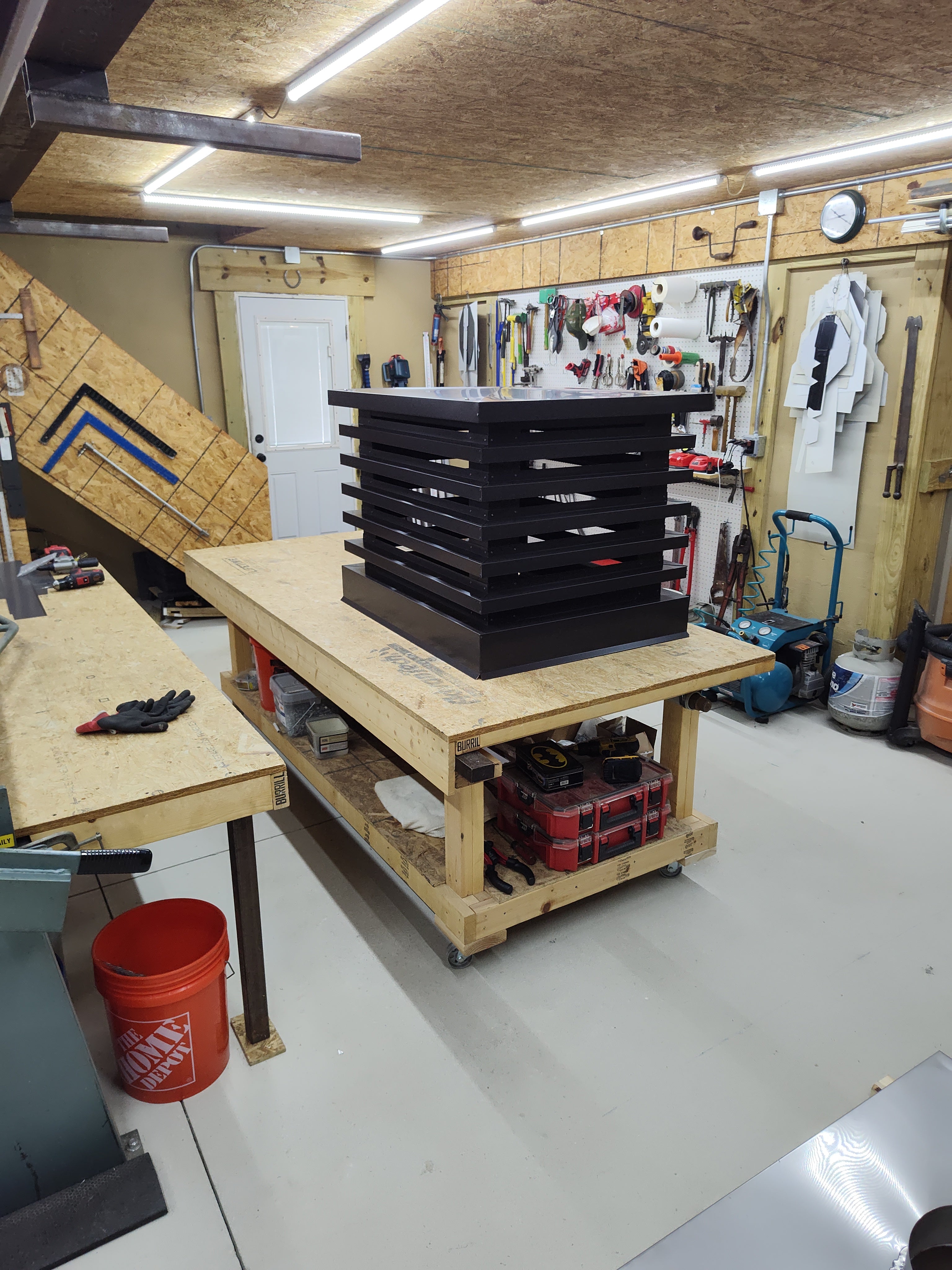 Custom louvered chimney caps on workbench in Archaic Metal fabrication shop Berlin NJ
