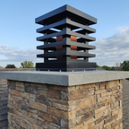 Custom louvered chimney flue cover in Kynar black aluminum installed on stone masonry chimney — top mount, hand-fabricated in Berlin NJ