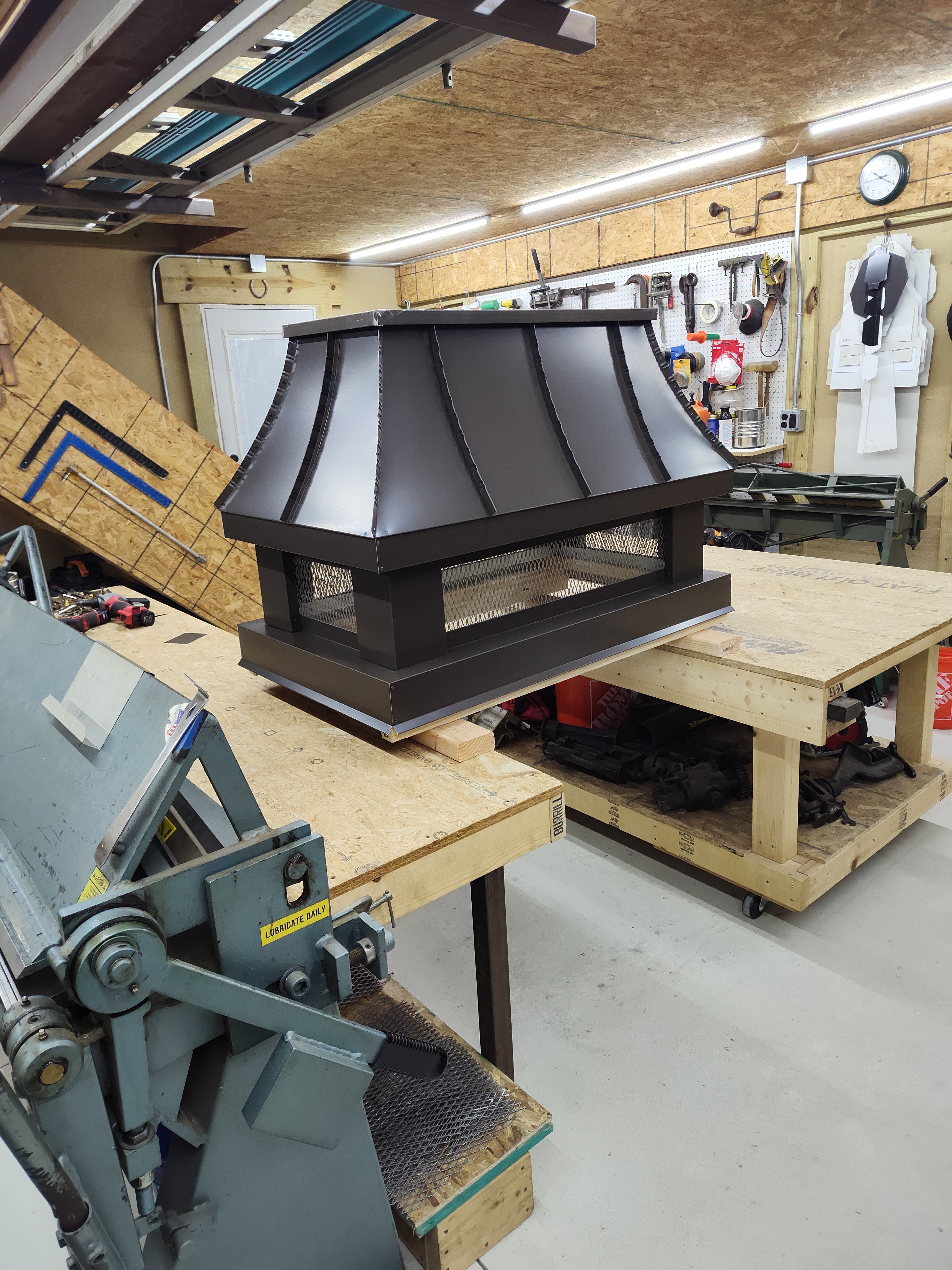 Midnight bronze Kynar aluminum chimney cap with spark screen — custom fabricated in the Archaic Metal shop, Berlin NJ