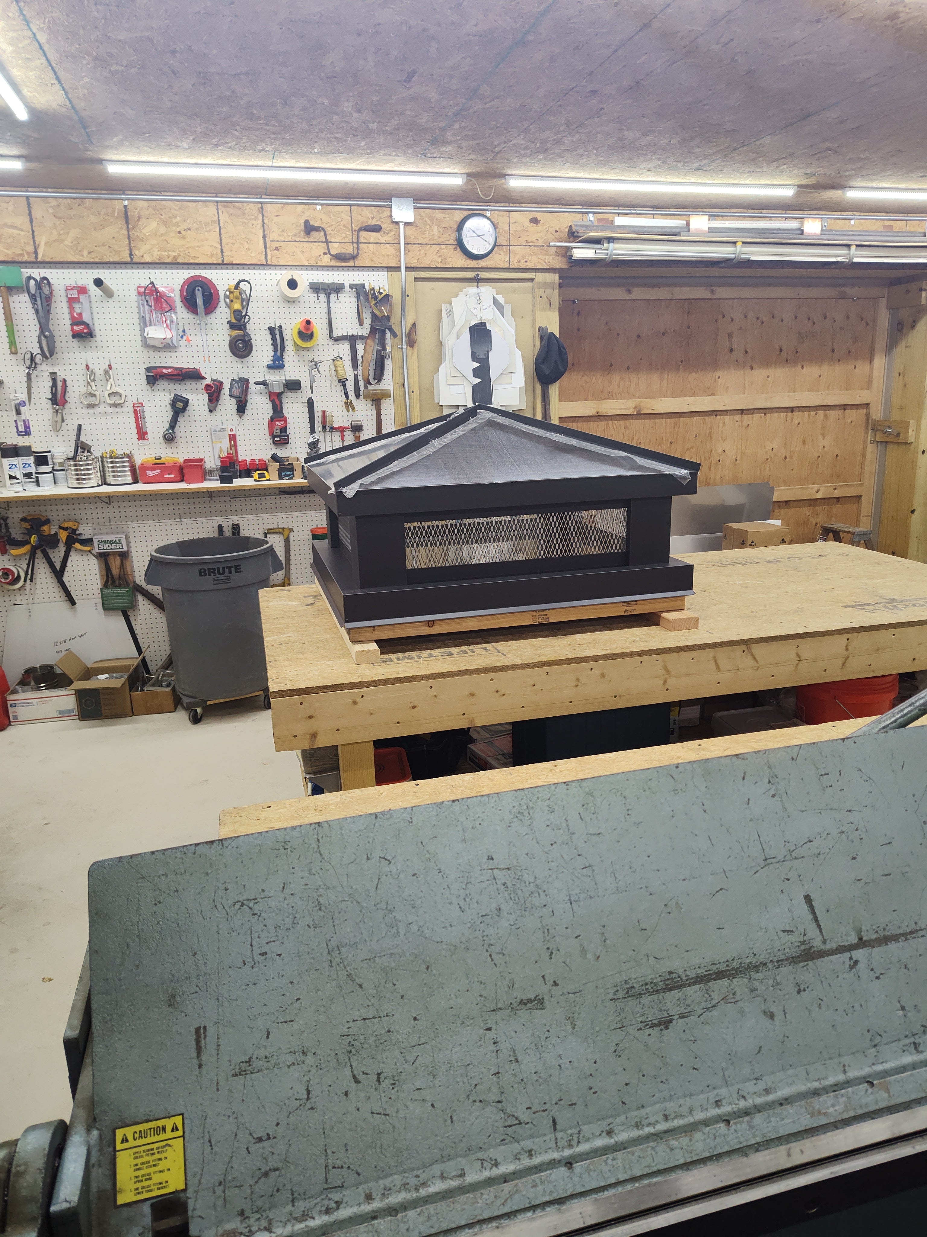 Custom Kynar aluminum hip chimney cap on rooftop — handcrafted by Archaic Metal

